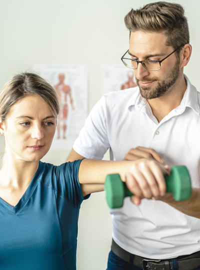 man helping woman hold hand weight properly