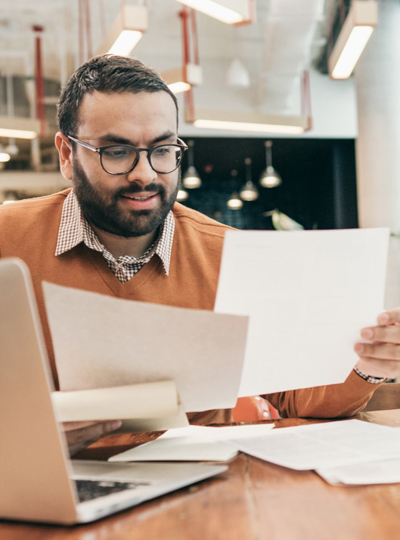 man at desk looking over paperwork