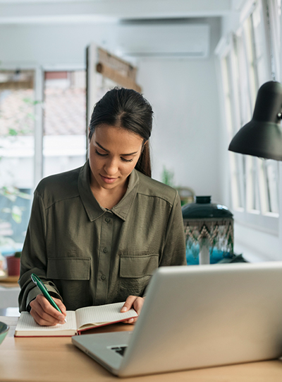 woman at desk practicing creative writing