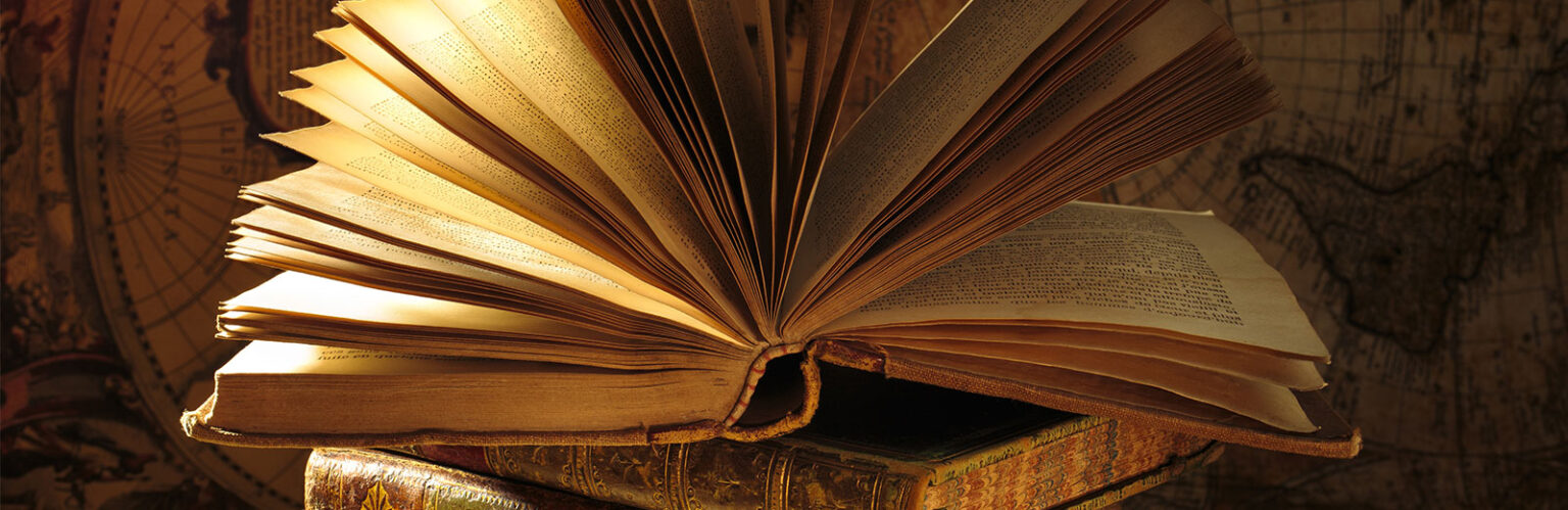 Open book on top of stack of books