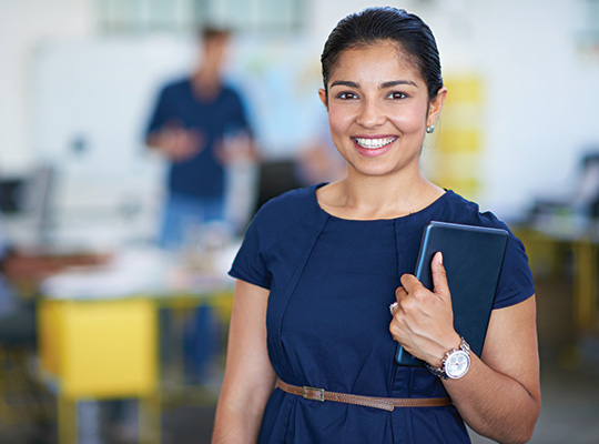 woman in blue dress holding tablet