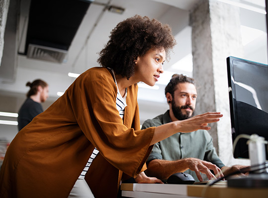 Marketing experts at desk with monitor